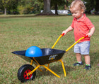 Boy pushing Kettler CAT wheelbarrow in the backyard