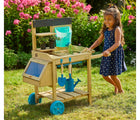 Girl playing with TP Toys Wooden Potting Bench outside in a yard. Available from tenlittle.com
