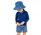 Child wearing Jan & Jul UV Swim Shorts in Shark with navy UV long sleeve top and shark bucket hat. Available from tenlittle.com