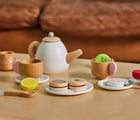 Small Foot Wooden Tea Party Set on a table next to a couch. Available from tenlittle.com