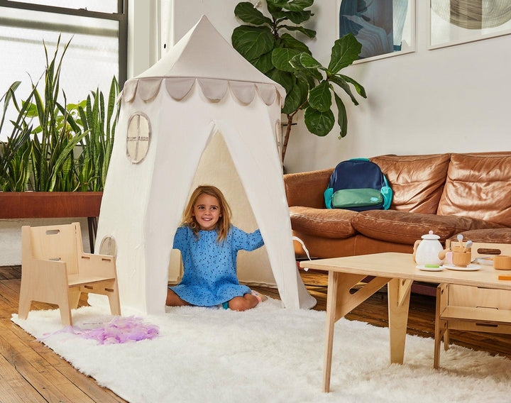 Child playing inside Domestic Objects Tower Tent in greige. Available from tenlittle.com