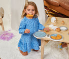 Girl playing with Small Foot Waffle Iron at table near the couch. Available from tenlittle.com