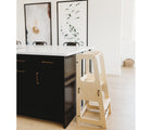 Piccalio Convertible Kitchen Helper Tower in natural next to kitchen table. Available from tenlittle.com