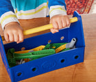 Child holding Green Toys 100% Recycled Pretend Tool Set. Available from tenlittle.com