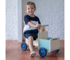 Boy riding Plan Toys Delivery Bike - Available at www.tenlittle.com