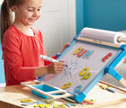Child playing with Melissa & Doug Double-Sided Tabletop Easel. Available from tenlittle.com