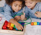 Two children playing with Melissa & Doug Primary Lacing Beads. Available from tenlittle.com