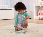 Child playing with Melissa & Doug Fishing Magnetic Puzzle Game on the floor. Available from tenlittle.com