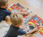 Children playing with Melissa & Doug Fire Truck Floor Puzzle - 24 Pieces on the floor. Available from tenlittle.com