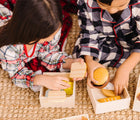 Two children playing with Melissa & Doug Food Groups. Available from tenlittle.com