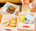 Child's hands playing with Melissa & Doug Food Groups. Available from tenlittle.com