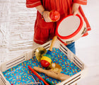 Child playing with tambourine from Melissa & Doug Band in a Box - Clap, Clang, Tap. Available from tenlittle.com