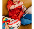 Child playing with triangle from Melissa & Doug Band in a Box - Clap, Clang, Tap. Available from tenlittle.com