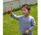 Child playing with instrument from Melissa & Doug Band in a Box - Hum, Jangle, Shake. Available from tenlittle.com