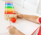 Child playing with Melissa & Doug Wooden Caterpillar Xylophone. Available from ten littlecom