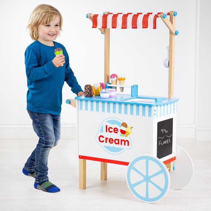 Child playing with Bigjigs Wooden Ice Cream Cart. Available from www.tenlittle.com.