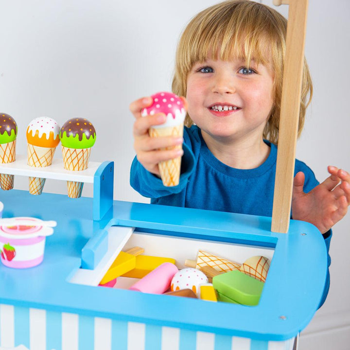 Child playing with Bigjigs Wooden Ice Cream Cart. Available from www.tenlittle.com.