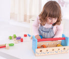 Girl playing with Bigjigs Workbench & Toolbox. Available from www.tenlittle.com.