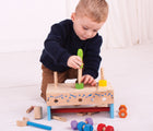 Boy playing with Bigjigs Workbench & Toolbox. Available from www.tenlittle.com.