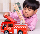 Boy playing with Bigjigs Fire Engine. Available from www.tenlittle.com.